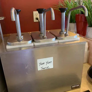 three stainless steel faucets on a counter