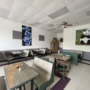 a dining area with tables and benches