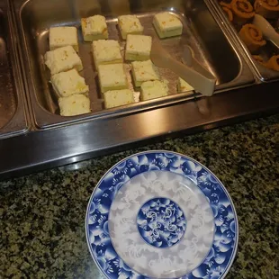 a blue and white plate and tray of food