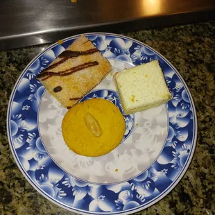 a blue and white plate with dessert items