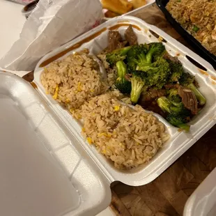 a tray of rice and broccoli