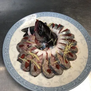 a plate of raw fish on a table