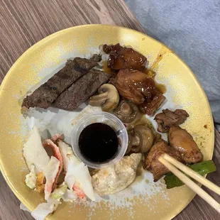 Steak, cooked mushrooms, teriyaki chicken and bourbon chicken, fried dumpling, crab bake