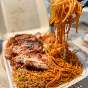 a plate of noodles and meat