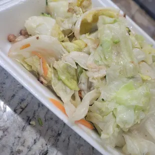 a salad in a styrofoam container
