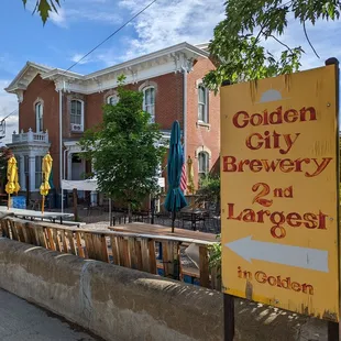 a sign in front of a brick building
