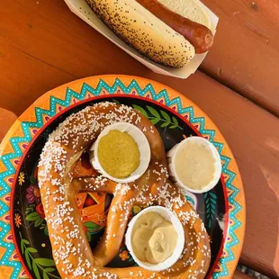 a plate of hotdogs with mustard and condiments