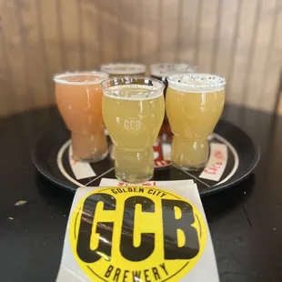 four glasses of beer on a plate