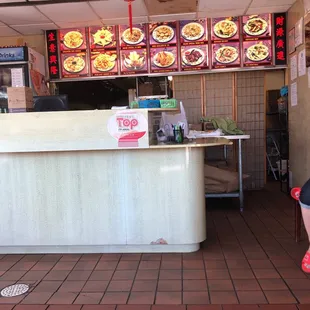 a woman sitting on a bench in front of a restaurant