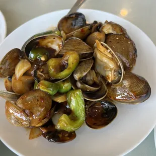 a plate of clams and brussels sprouts