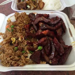 Boneless spare ribs with pork fried rice in foreground and Mongolian beef with steamed rice in background