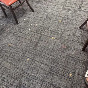 Had to step over all this food in the carpet just to get to any available table.. looks like it hadn&apos;t been cleaned all day