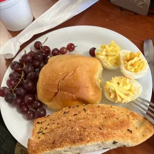 Grapes, garlic bread, dinner rolls, deviled egg