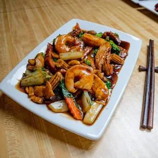 a plate of food with chopsticks