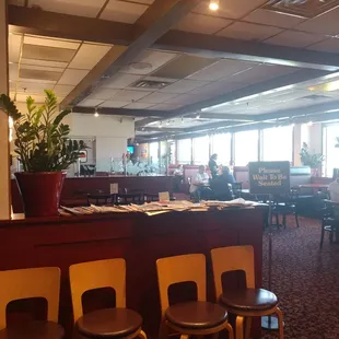 a restaurant with a bar and chairs