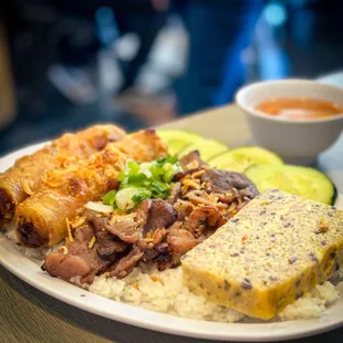 grilled pork with egg rolls and steamed egg and broken rice