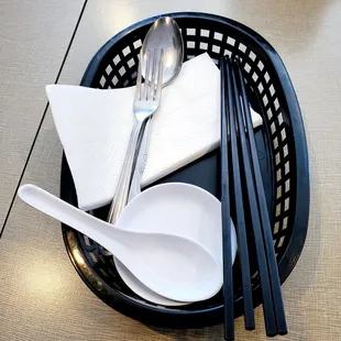 The napkins and utensils are brought to each table. They are no longer at the tables.