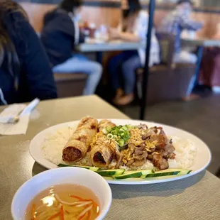 Broken rice with grilled pork and egg rolls