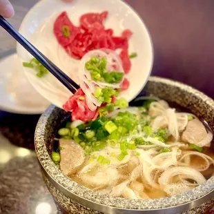 Their Pho is served in stone pot and you mix in the beef and noodles as well as the vegetables...