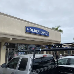 a truck parked in front of a donut shop