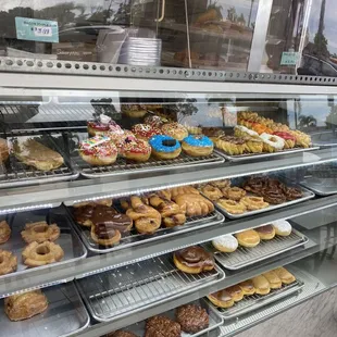 a variety of donuts in a display case