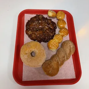 a variety of pastries on a red tray