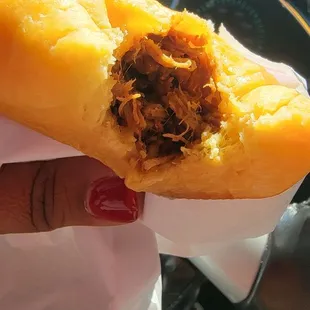 the inside of a bun with meat