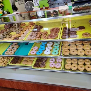 a variety of donuts in a display case