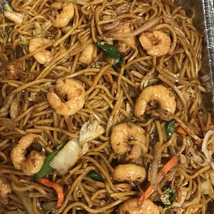 shrimp and noodles in a foil container