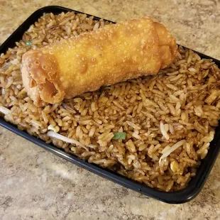 a plate of fried rice and a roll