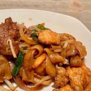 House Special Chow Fun. Flat rice noodles with chicken, beef, and shrimp. Bean sprouts and onions top this dish.