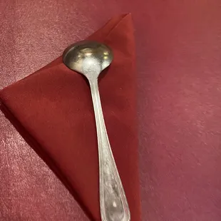 a spoon on a red napkin