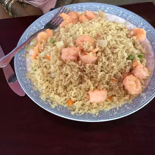 a plate of rice with salmon and peas