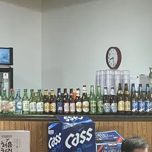 a man sitting at a counter in a liquor shop