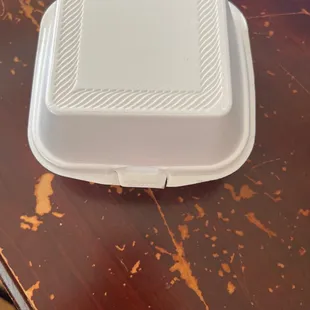 a white container on a wooden table