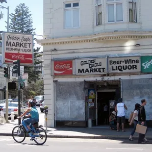 a man riding a bike in front of the store