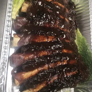 ribs and lettuce in a foil container