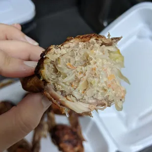 a person holding a piece of food