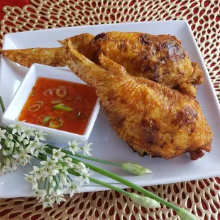 a plate of fried chicken with dipping sauce