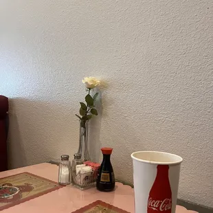 a table setting with a coca cola cup