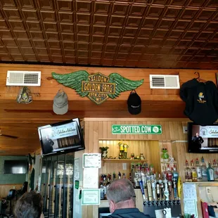 a bar with a man sitting at the bar