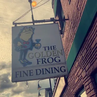a sign for the golden frog fine dining