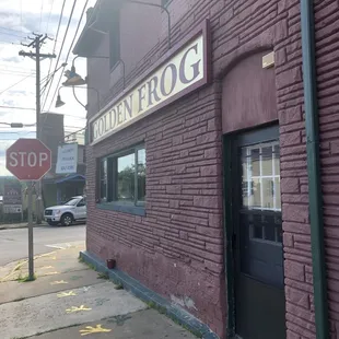 a stop sign in front of a brick building