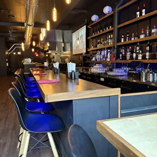 a bar with blue chairs