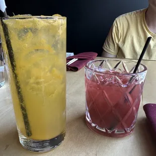 a man sitting at a table with a glass of lemonade