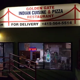 the entrance to indian cuisine and pizza restaurant