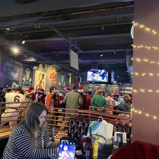 a woman taking a picture of the bar