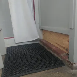 Exposed wood in the showers in the men's bathrooms.