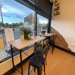 a table and chairs in front of a window