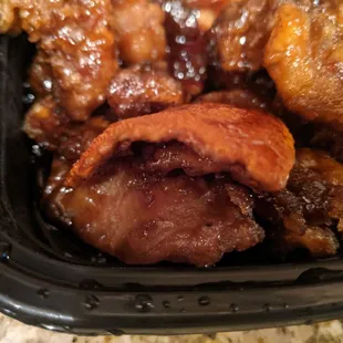 Orange Chicken (the outside of it, served with dried out orange peels dripping with sauce)